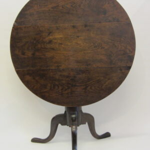 An 18th Century English country oak tilt top wine table