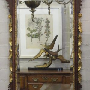 A rare 18th Century English Chippendale walnut and parcel gilt looking glass