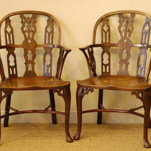 A rare pair of 18th Century yew wood Gothic Windsor elbow chairs