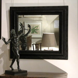 An Early 19th Century Flemish ribbon carved ebonized wall mirror