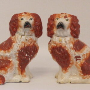 A pair of mid 19th Century English Staffordshire seated rust coloured Spaniels