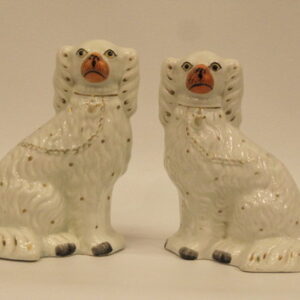 A pair of 19th Century English Staffordshire white seated Spaniels