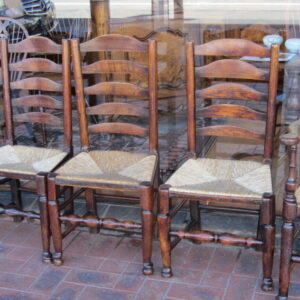 A harlequin set of eight first half 19th Century English country ash and alder ladder back chairs