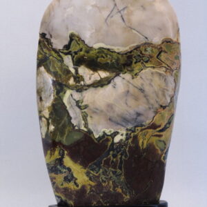 A polished onyx natural sculpture on an ebonized base