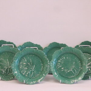 Eight 20th Century English green majolica plates