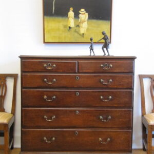 A late Georgian English oak cross banded chest of drawers of large proportions