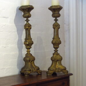 A pair of 19th Century French beaten brass torchieres with shell motifs