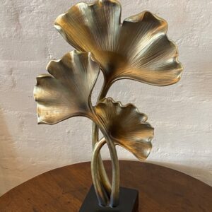 Carved Japanese Ginkgo Biloba leaf gold coloured sculpture, on square blackened platform.