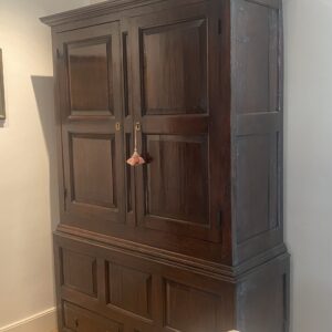 A rare first half 18th century English oak clothes press.