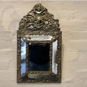 An unusually small 19th Century Flemish hanging messing (brass) cushion shaped mirror, with pierced and embossed ormolu mounts.