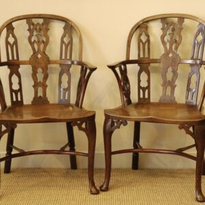A rare pair of 18th Century yew wood Gothic Windsor elbow chairs