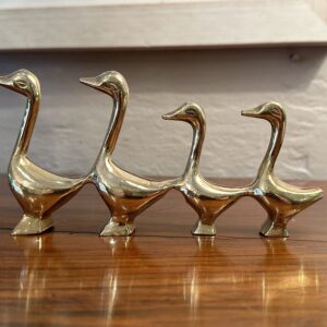 An old family of four solid brass ducks.