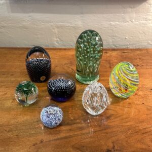 Several stylish 20th century European paperweights and a 19th century English green bubbled glass dump.