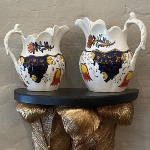 Pair of mid 19th century English pottery jugs, with floral and gilt decoration.