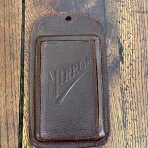 A rare embossed leather Art Nouveau travel mirror.
