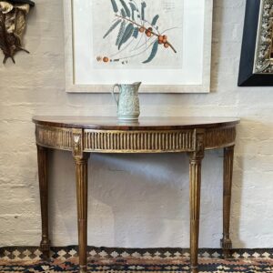 A magnificent late 18th century, George III painted and gilded satinwood demilune side table.