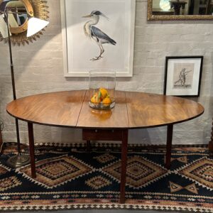 An unusually shaped 18th century English well faded mahogany D-end drop side dining table.