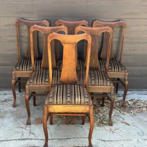 A rare set of stylish European oak Queen Anne revival dining chairs.