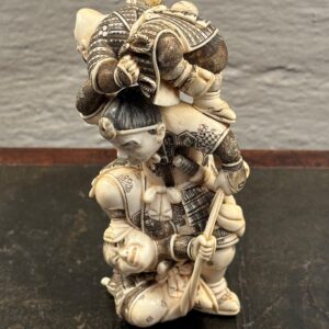 A rare 19th century Japanese Meiji Period carved ivory Netsuke, of a man fighting two robbers.