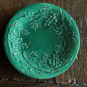 19th century English green majolica plate decorated with an embossed grape and vine leaf pattern. 